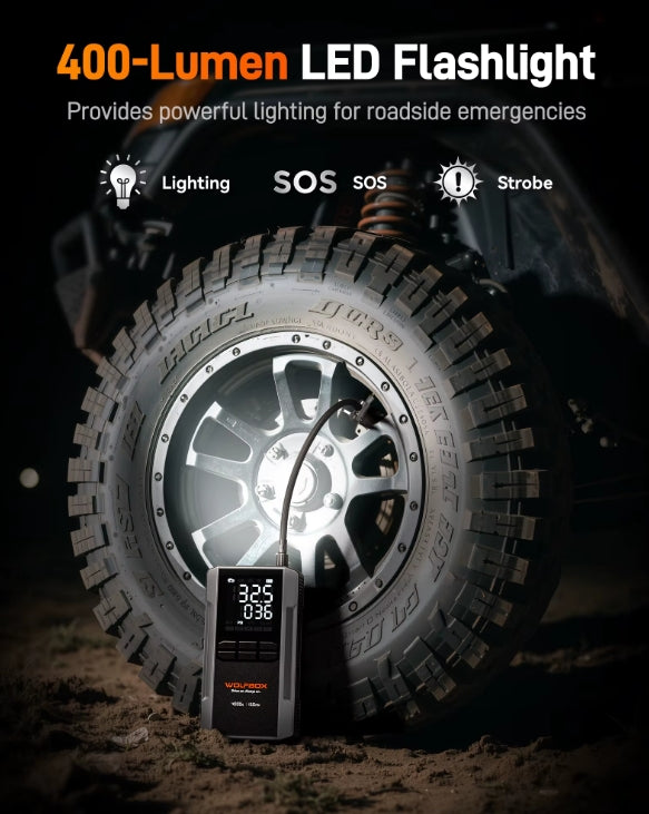 Jump starter with 400-Lumen LED flashlight with tire and digital thermometer in dark setting