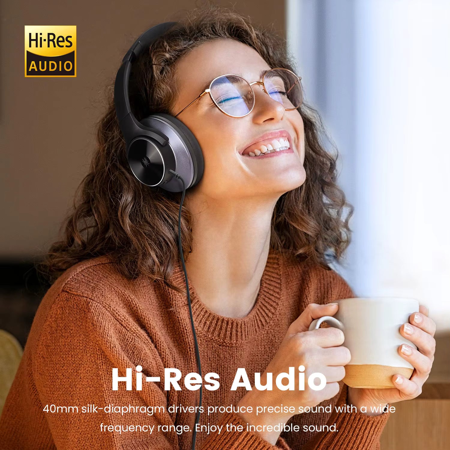 A woman wearing over-ear OneOdio A10 Hybrid ANC Over-Ear Bluetooth Headphones Hi-Res Audio  and holding a mug, smiling and looking upward in a bright indoor setting. The image includes the text 'Hi-Res Audio' and a small Hi-Res Audio logo in the top left corner.