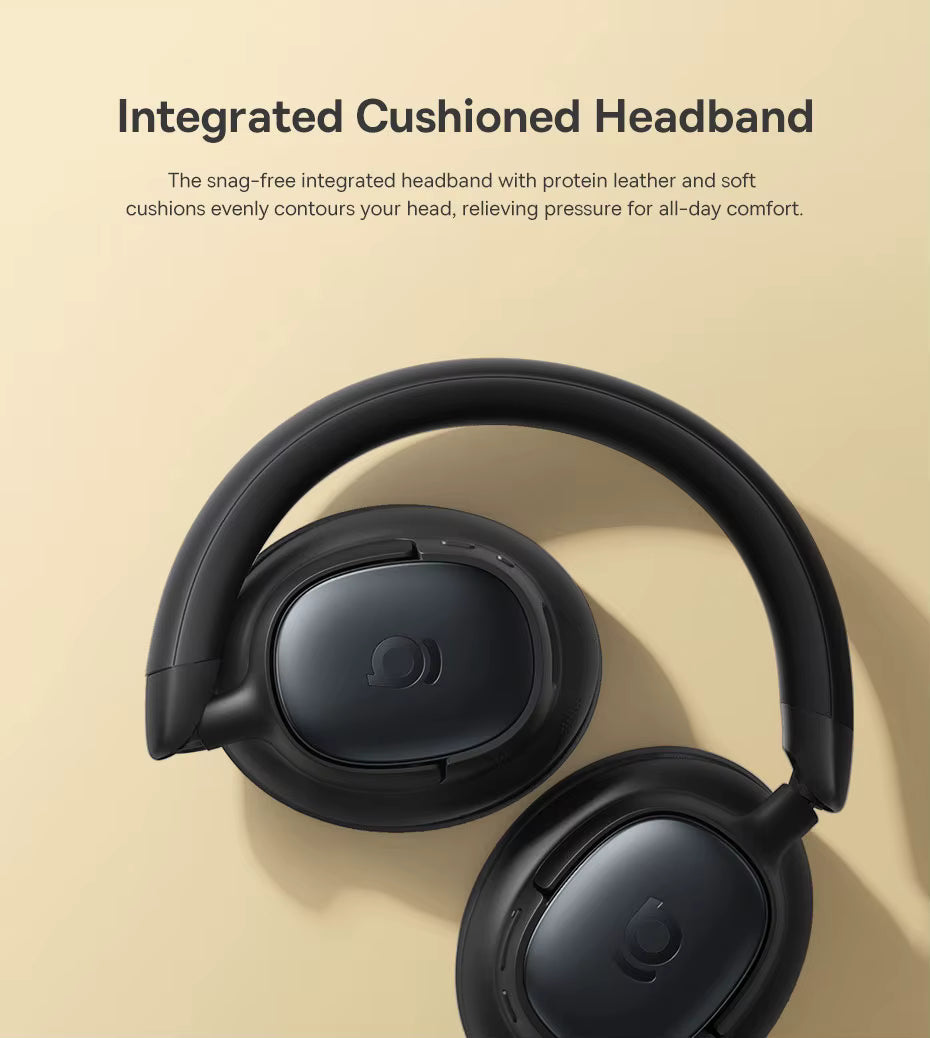 Close‑up of Baseus Bowie MH1 over‑ear headphones resting on a beige surface, showing the integrated cushioned headband and soft protein leather ear pads with the text “Integrated Cushioned Headband,” highlighting ergonomic design and all‑day comfort.