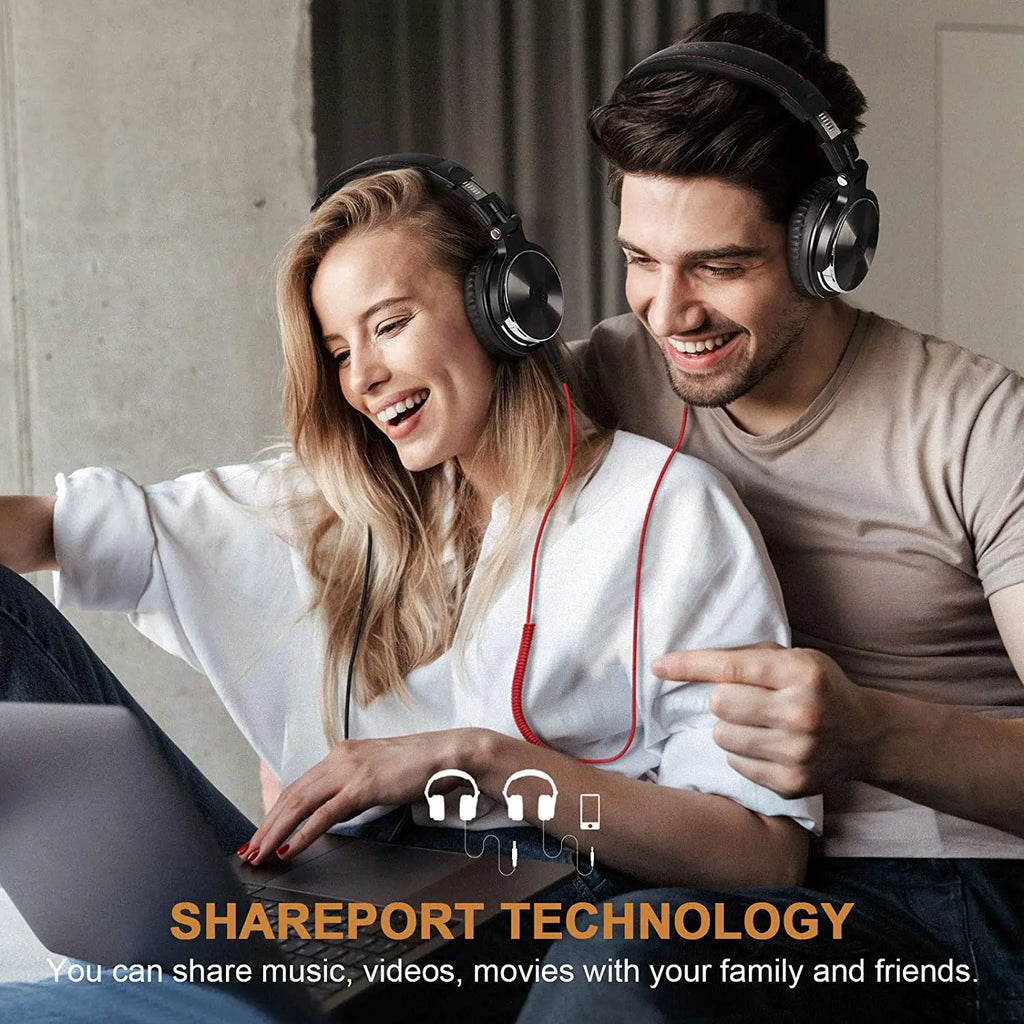 Two people wearing headphones, smiling and looking at a laptop with Shareport Technology branding.