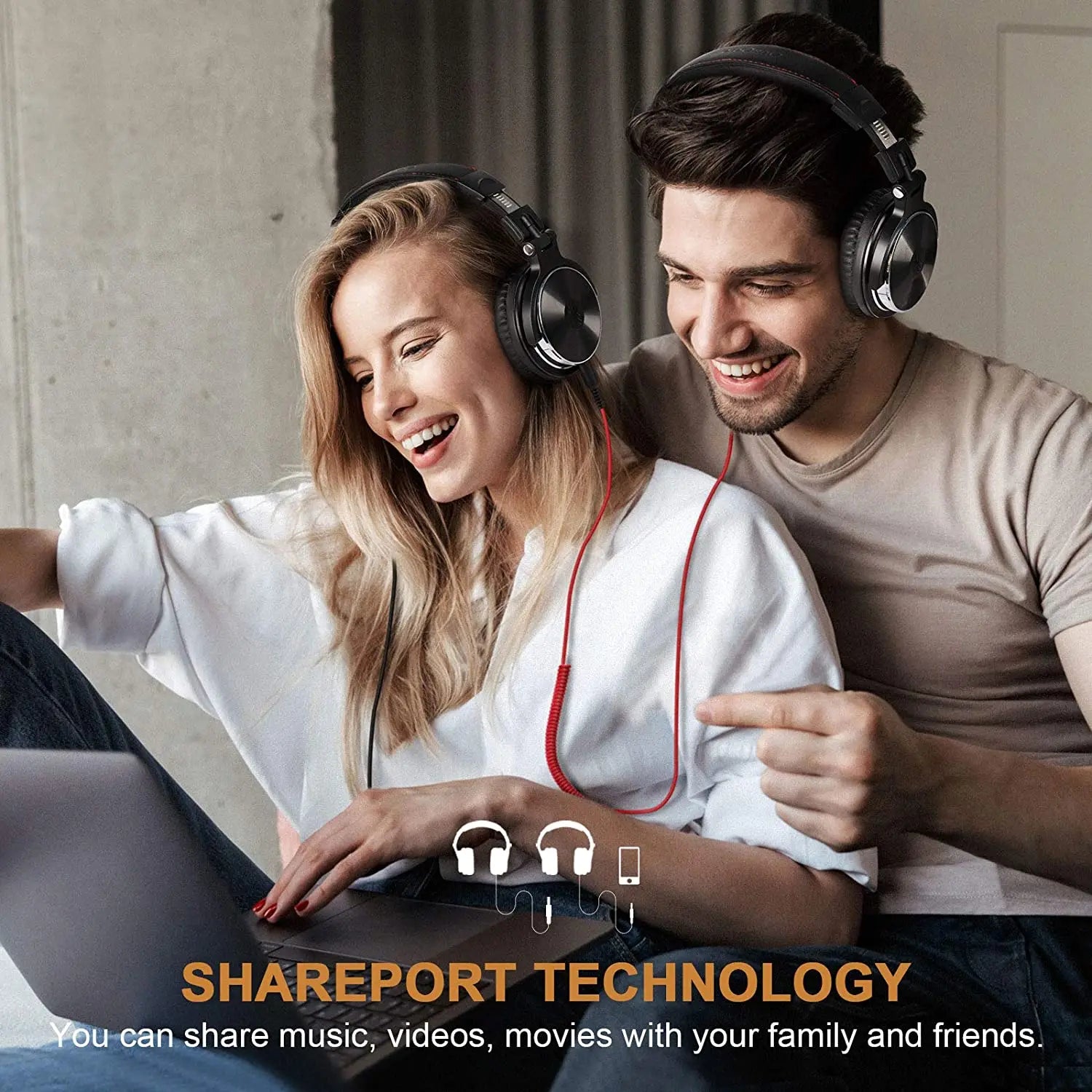 Two people wearing headphones, smiling and looking at a laptop with Shareport Technology branding.