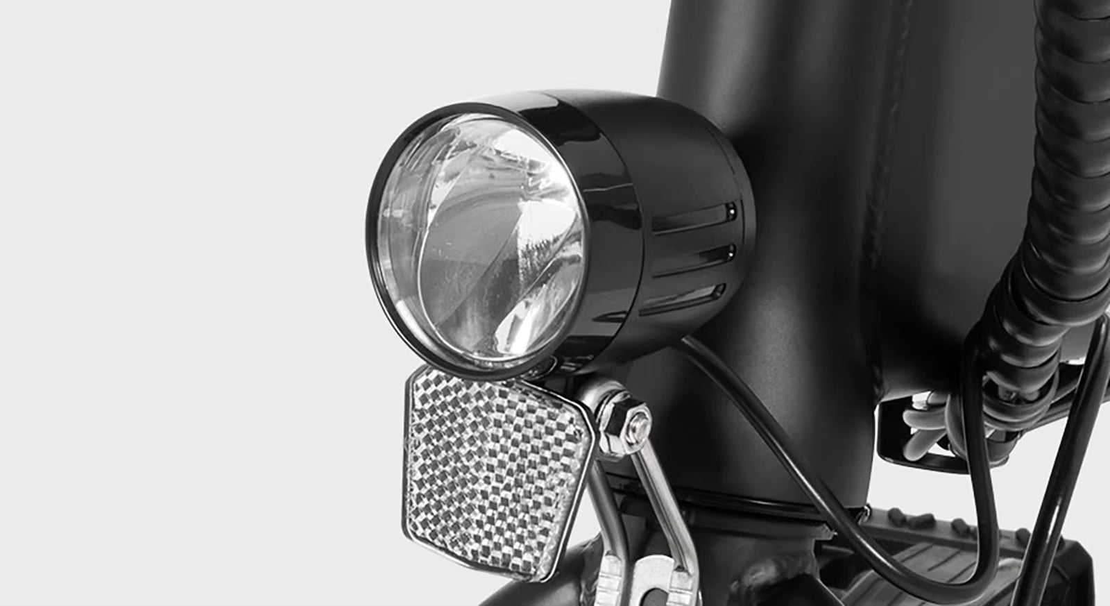 Close-up of a  DYU A1F Pro Folding E-Bike  electric bicycle headlight with a clear background