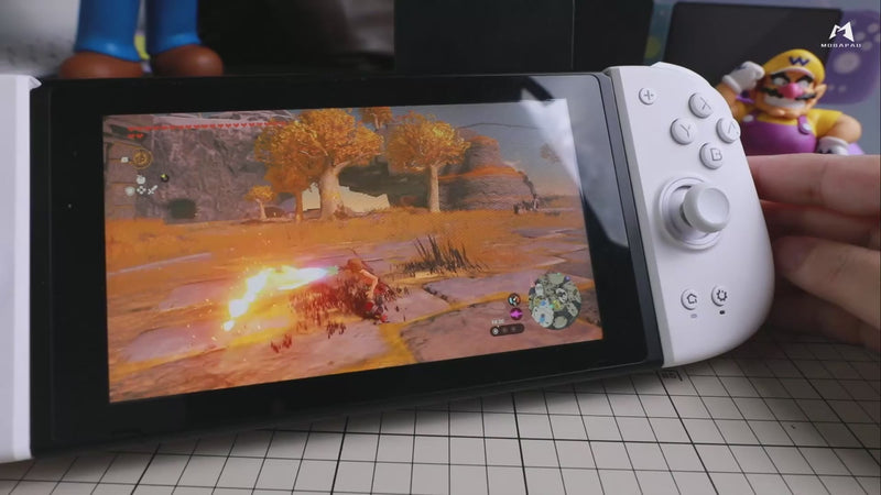 Video thumbnail showing the Mobapad M6 HD Pink controller attached to a Nintendo Switch console, with character figures visible in the background.