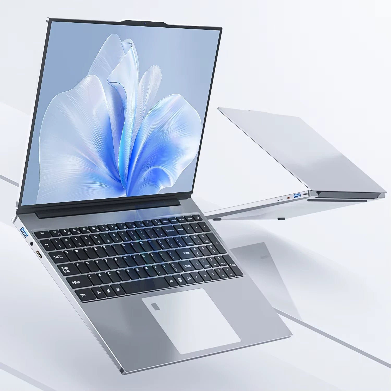 Open laptop with a flower design on the screen on a light gray background