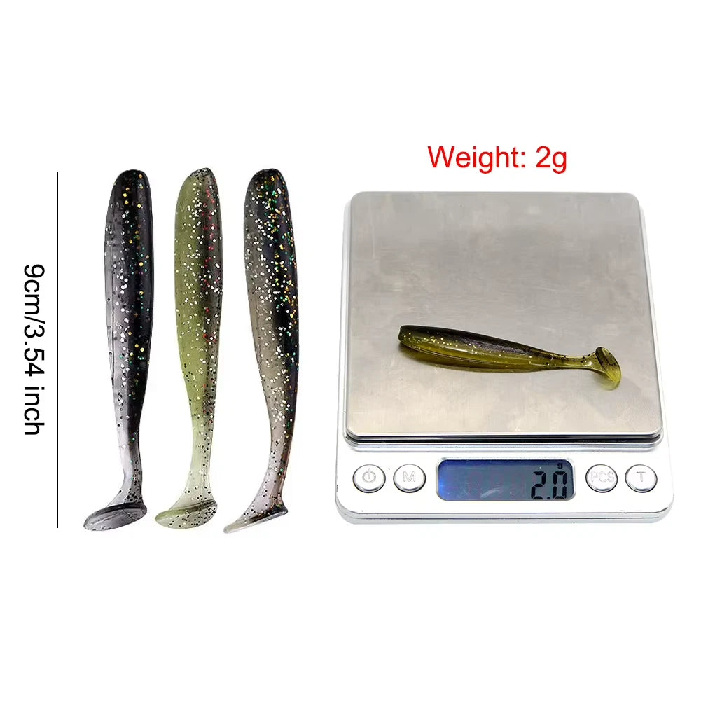 Three fishing lures next to a digital scale showing weight and dimensions.